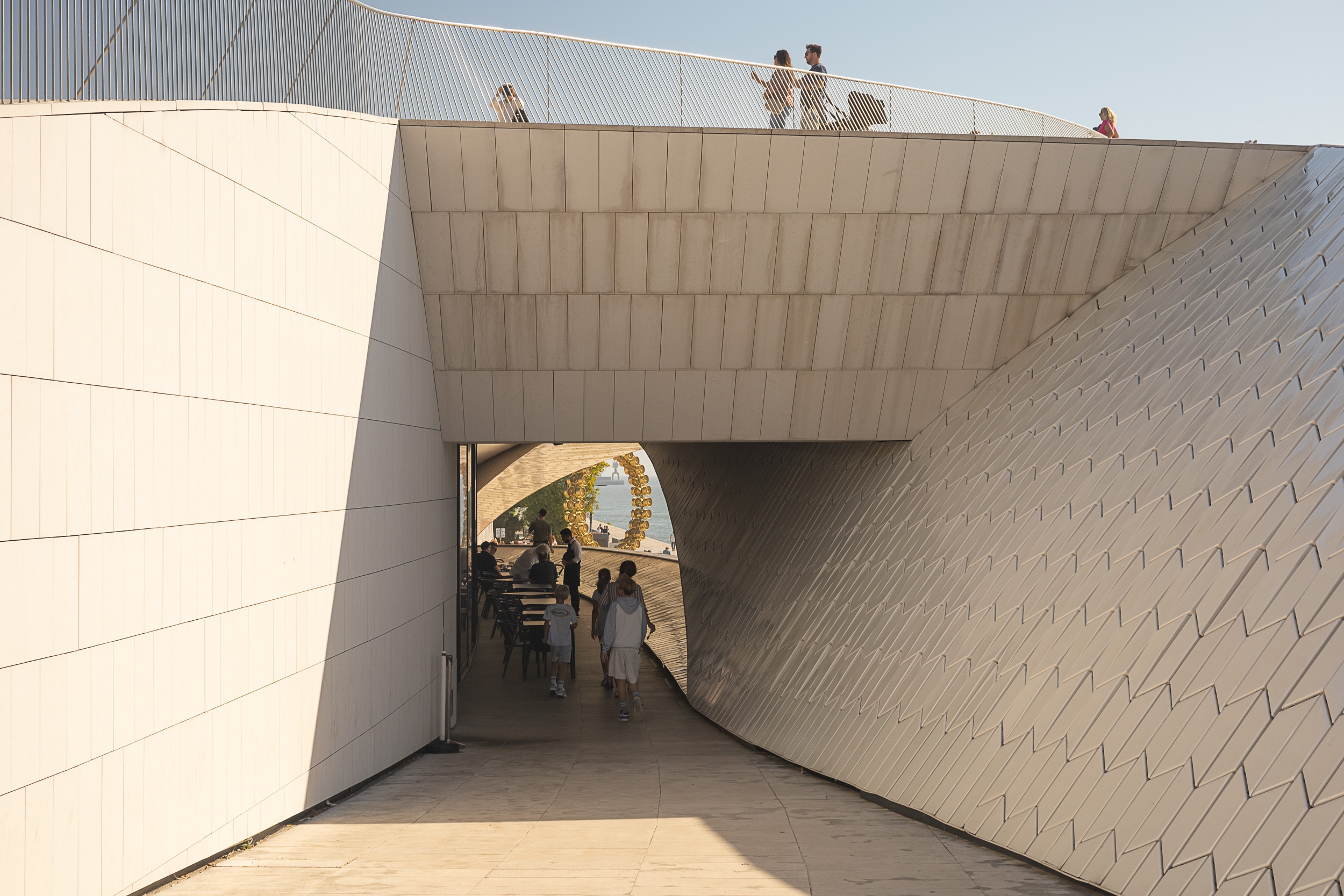 The sweeping, modern facade at the entrance of the MAAT museum in Lisbon