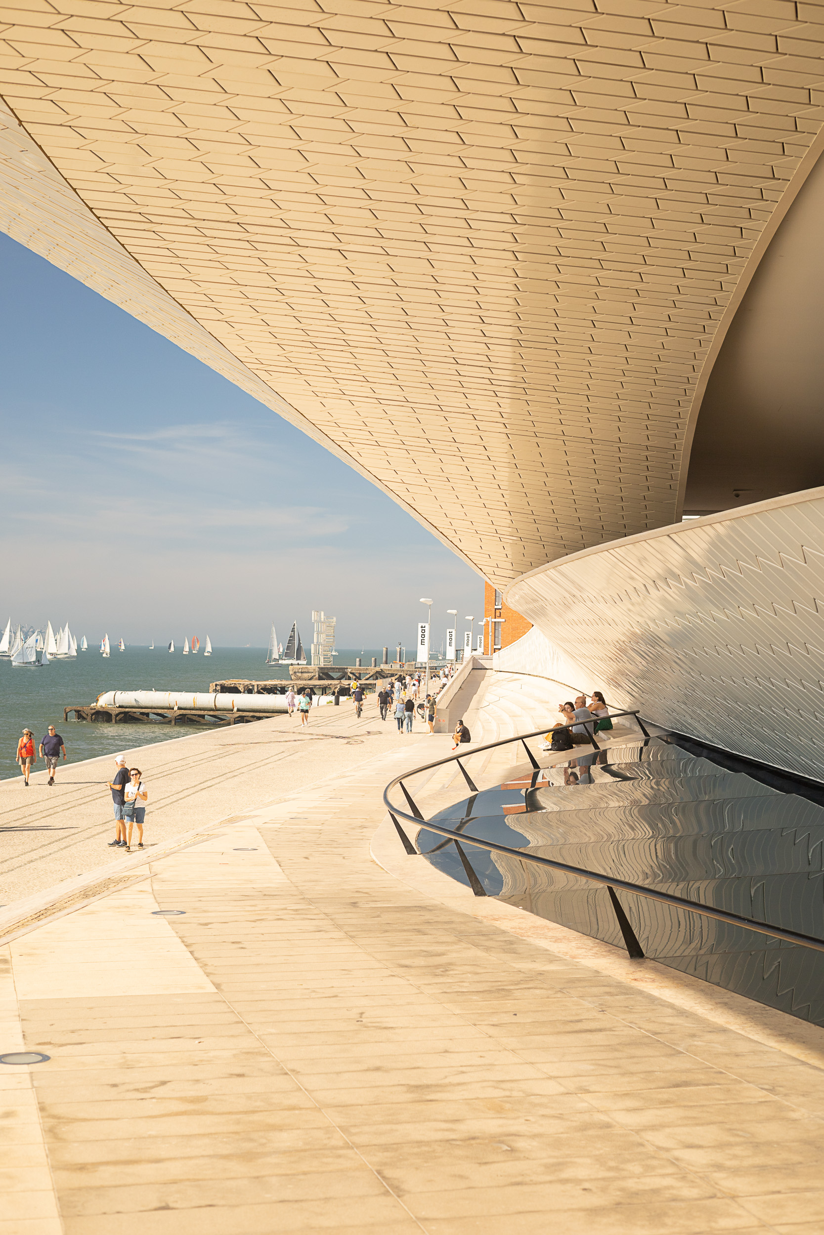 The modern, wave-like building of the MAAT museum on the banks of the Tagus River