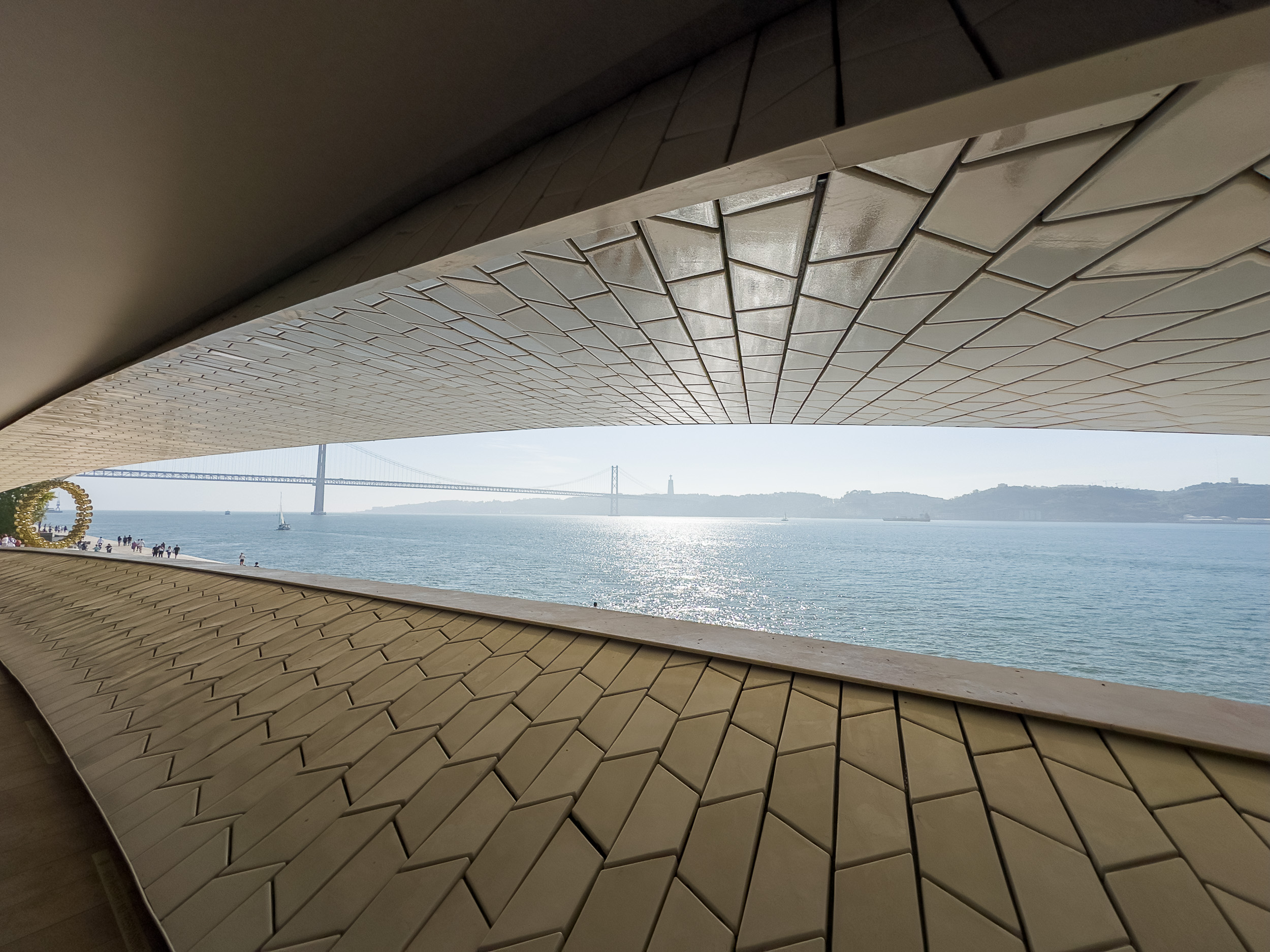 Expansive view from the roof of the MAAT over the Tagus River and the red suspension bridge Ponte 25 de Abril