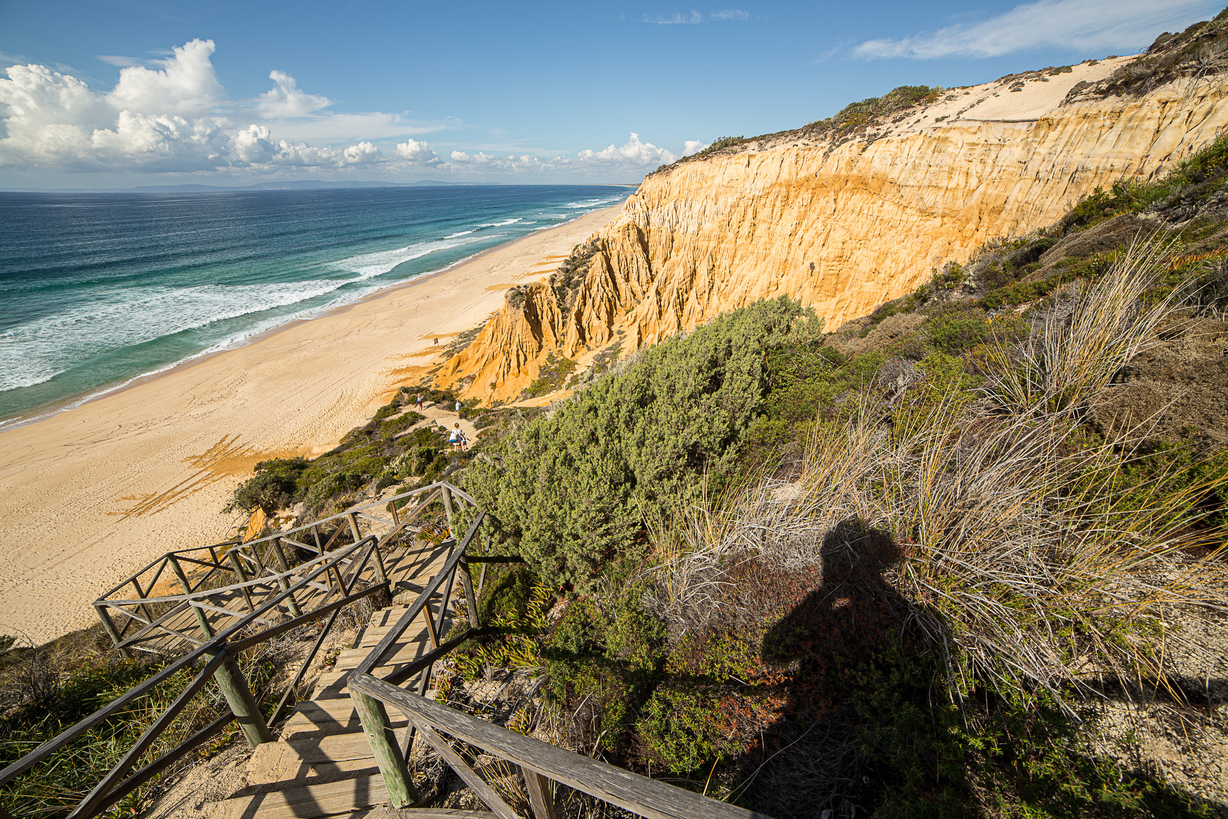 Spectacular access to Praia da Galé beach with rugged red sandstone cliffs