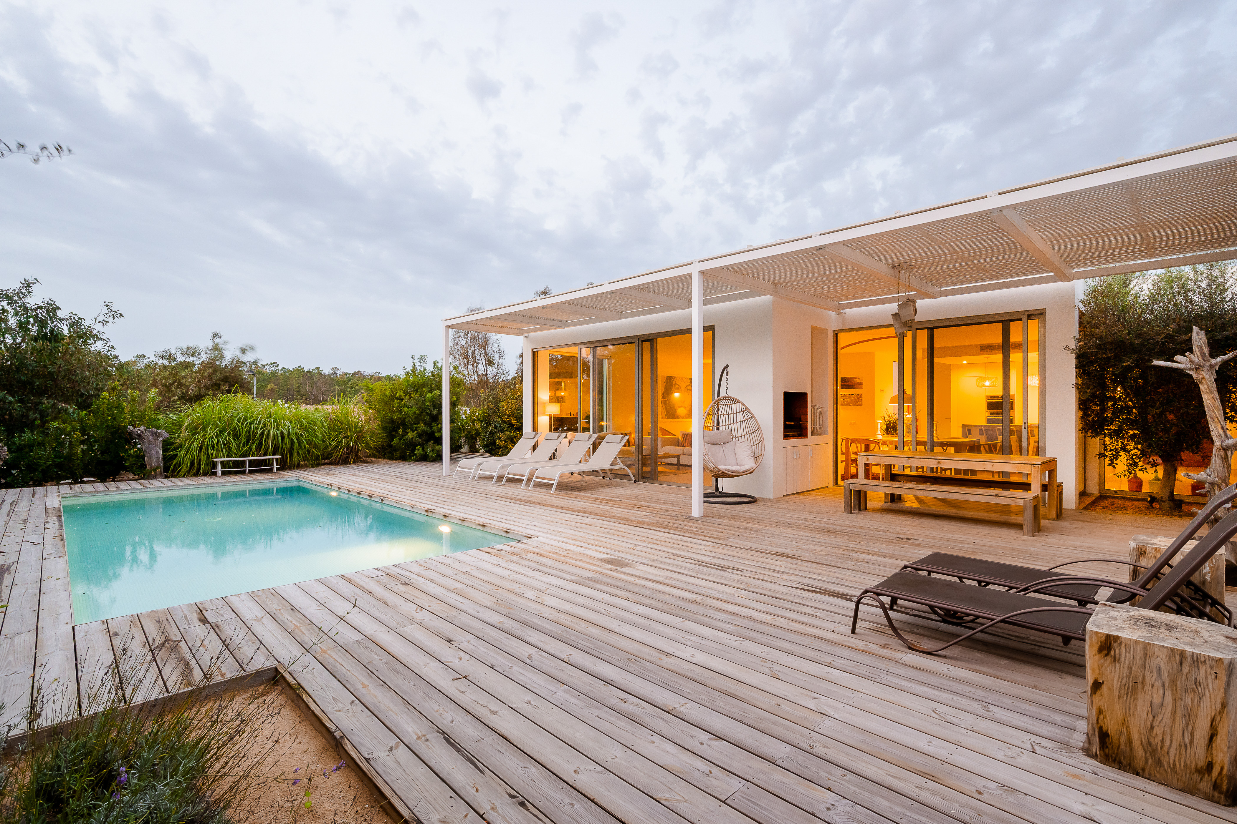 Die beleuchtete Villa Laranjeiras spiegelt sich am Abend ruhig im privaten Salzwasserpool